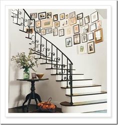 a staircase with pictures on the wall