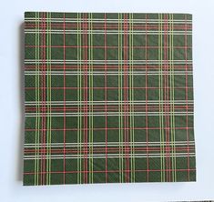 a green and red plaid paper napkin on a white surface