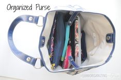 an organized purse is shown with several items in the bottom compartment, including pens and pencils