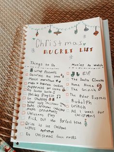 a christmas bucket list is shown in a notebook