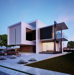 a modern house with two cars parked in the driveway and landscaping around it at dusk