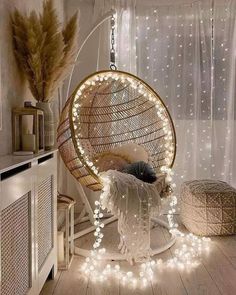 a hanging chair with lights around it