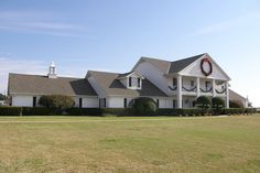 a large white house with a wreath on it's roof