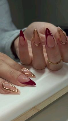 Maroon Acrylic Nails Almond, Dark Red With Gold Nails, Red And Metallic Nails, Red Ethereal Nails, Wine Red Nail Inspo Almond, Emerald Green And Gold Almond Nails, Vintage Almond Nails, Makeup For Maroon Outfit, Cranberry And Gold Nails