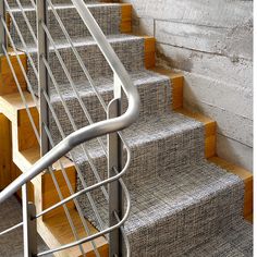 the stairs are made of metal and wood with carpeted treads on both sides