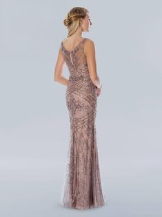 the back of a woman wearing a long dress with sequins and beading