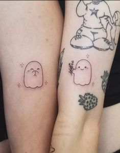 two people with matching tattoos on their arms, one has a bear and the other has a bird