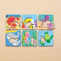 four wooden puzzles with different sea animals on them