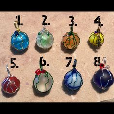 twelve different colored glass ornaments with numbers on them