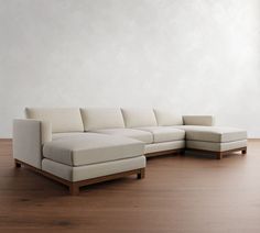 a white couch sitting on top of a wooden floor