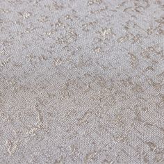 an upholstered fabric textured with small flowers and leaves in light grey tones