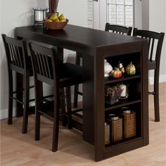 a kitchen table with two chairs and a shelf filled with fruits and vegetables on it