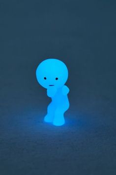 a small blue toy sitting on top of a table