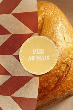 a loaf of bread sitting on top of a red and white checkered table cloth