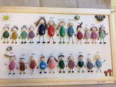 a group of small figurines sitting on top of a wooden frame