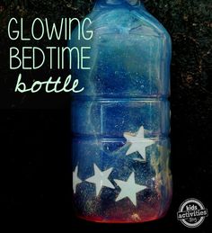 a blue bottle with white stars painted on it and the words glowing bedtime bottle