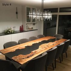 a dining room table made out of wood with chairs around it and a chandelier hanging from the ceiling