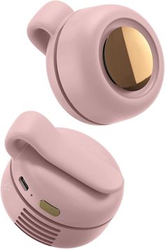 the pink earbuds are next to each other with gold accents on their ears