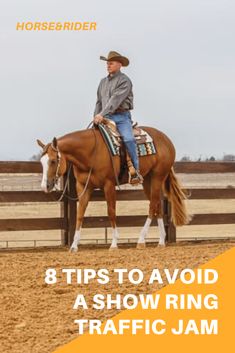 a man riding on the back of a brown horse next to a white and orange sign