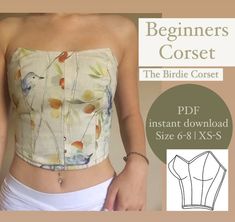 a woman wearing a crop top with flowers on it and the text, beginner's corset