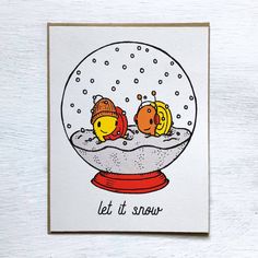 a snow globe with two fish in it and the words let it snow written below