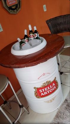 several bottles of beer are sitting in an ice bucket on top of a bar table