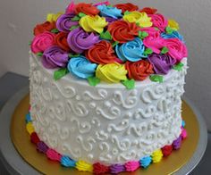 there is a white cake with colorful flowers on it