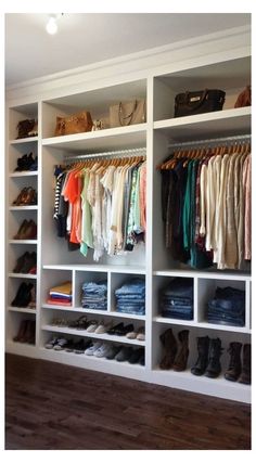 an organized closet with clothes and shoes on the shelves in front of it is shown