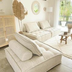 a living room filled with furniture and a large window