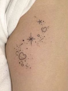 a woman's thigh with stars and hearts tattoo on her left side ribcage