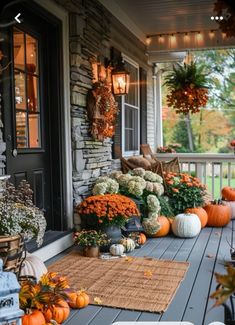 an outdoor porch decorated for fall with pumpkins and gourds