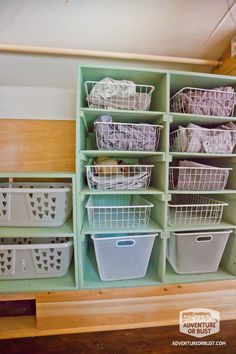 the shelves are filled with plastic baskets and other storage bins on top of them