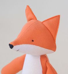 an orange stuffed fox sitting on top of a table