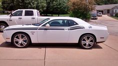 a white and black car is parked in the driveway