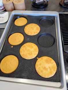 four pancakes sitting on top of a pan in the oven, ready to be baked