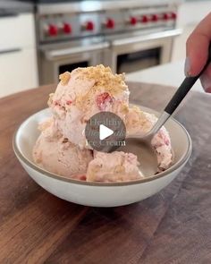 a person is cutting up some food in a bowl on a table with a knife