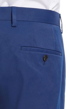 Crisp, classic and versatile, these staple flat-front chinos sport a handsomely tailored fit and a creased finish that keep them smart styled up or down. 14" leg opening; 10" front rise; 15" back rise (size 32) Zip fly with hook-and-bar closure Front slant pockets; back button-welt pockets Partially lined Unhemmed. Get the perfect fit—book an appointment with one of our alterations experts 100% polyester Dry clean Made in Turkey Men's Clothing Classic Chino Cotton Twill Dress Pants For Work, Classic Formal Chinos In Chino Cotton Twill, Tailored Chinos With Welt Pockets For Business Casual, Fitted Solid Color Chinos With Welt Pockets, Fitted Chinos With Welt Pockets For Business Casual, Classic Blue Chinos, Elegant Fitted Chinos In Cotton Twill, Tailored Formal Chino Cotton Twill Chinos, Formal Chino Cotton Twill Pants With Welt Pockets