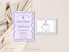 the wedding stationery is laid out on top of some fanned paper and placed next to each other