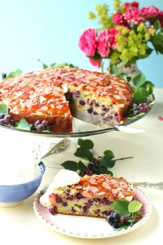 a piece of cake on a plate with flowers in the background