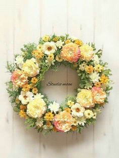 a wreath with flowers hanging on the wall