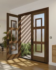 an open glass door in a room with wooden flooring and windows on both sides