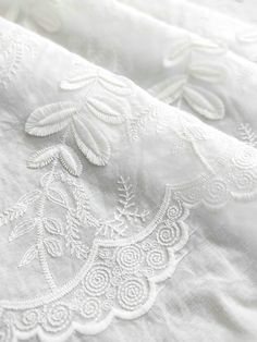 closeup of white linen with embroidered details