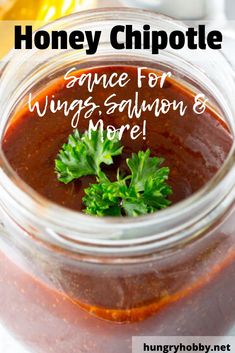 honey chipotle sauce for wings, salmon and more in a glass jar with parsley on top