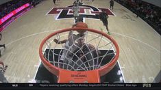 the basketball player is going to dunk the ball into the hoop with his hands