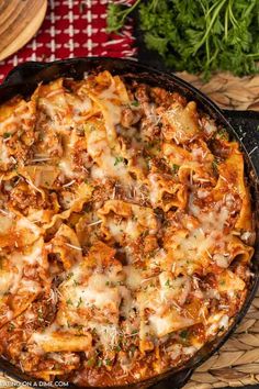 a casserole dish with meat and cheese in a cast iron skillet on a table