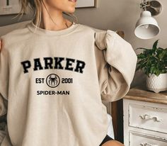 Spider-man Sweatshirt, Parker 2001 Sweatshirt, Peter Parker, Avengers Team Shirt,Spiderman Party,Marvel Sweatshirt,Superhero Shirt,parker te We design trendy sweatshirts that you can use in every important day of your life. We produce beautiful and quality designs that can be used in all kinds of activities that you will do with your family or friends. These designs will offer you and your environment a unique complement. We are very excited to bring you our high quality and soft, trendy sweatsh 1989 Hoodie, 1989 Sweatshirt, National Park Sweatshirt, Witch Sweater, Birthday Sweater, Trendy Sweatshirts, National Park Gifts, Birthday Sweatshirt, Men Sweatshirt