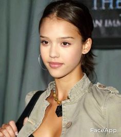 a young woman wearing a jacket and earrings