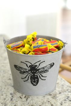 a bucket filled with candy sitting on top of a counter