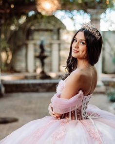 a woman wearing a pink dress and a tiara