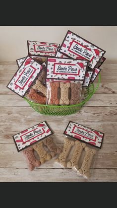 dog treats are in a green bowl on a wooden table with white and red labels